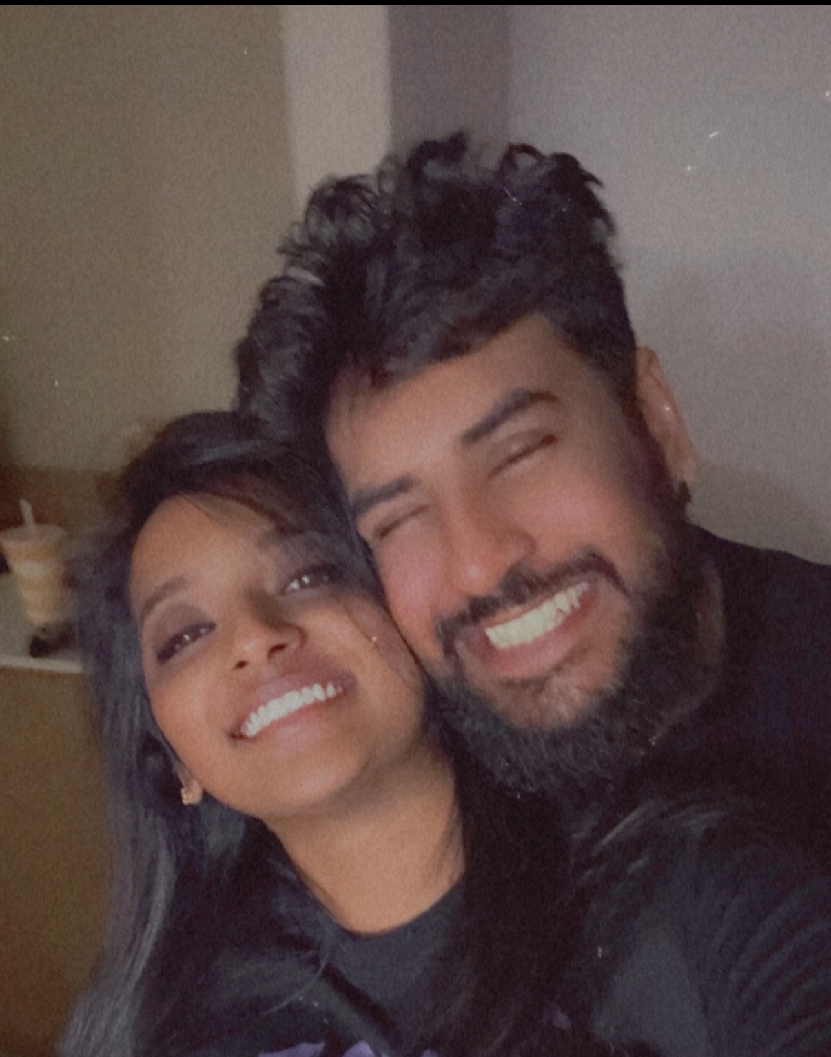 Selfie of the couple laughing cheek to cheek