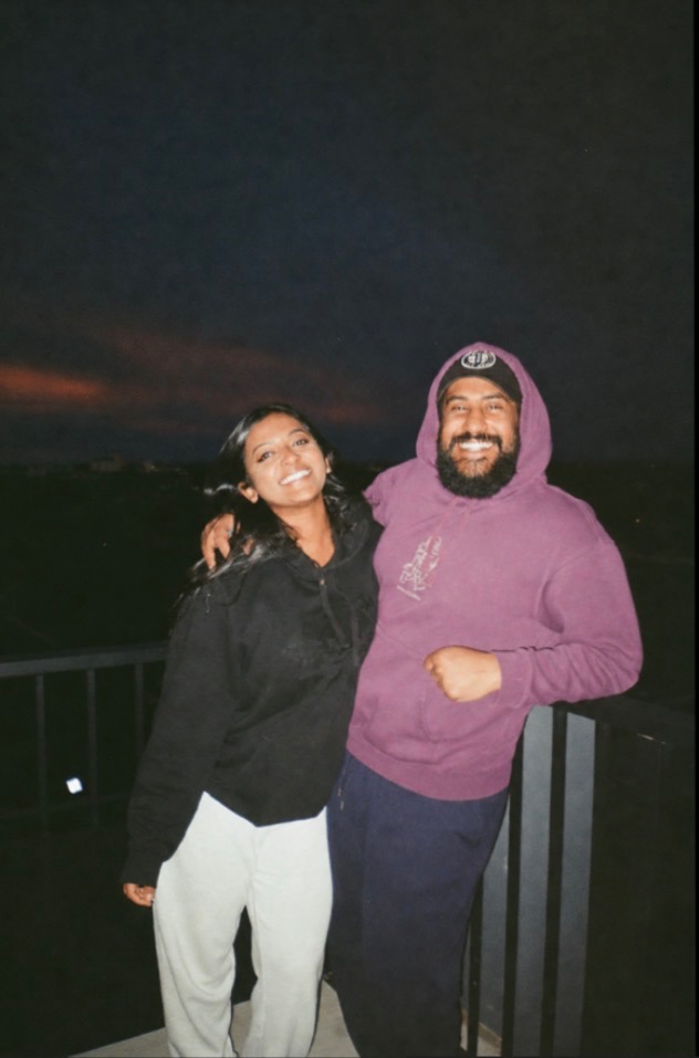 Vinoth and Kassandra smiling together at dusk