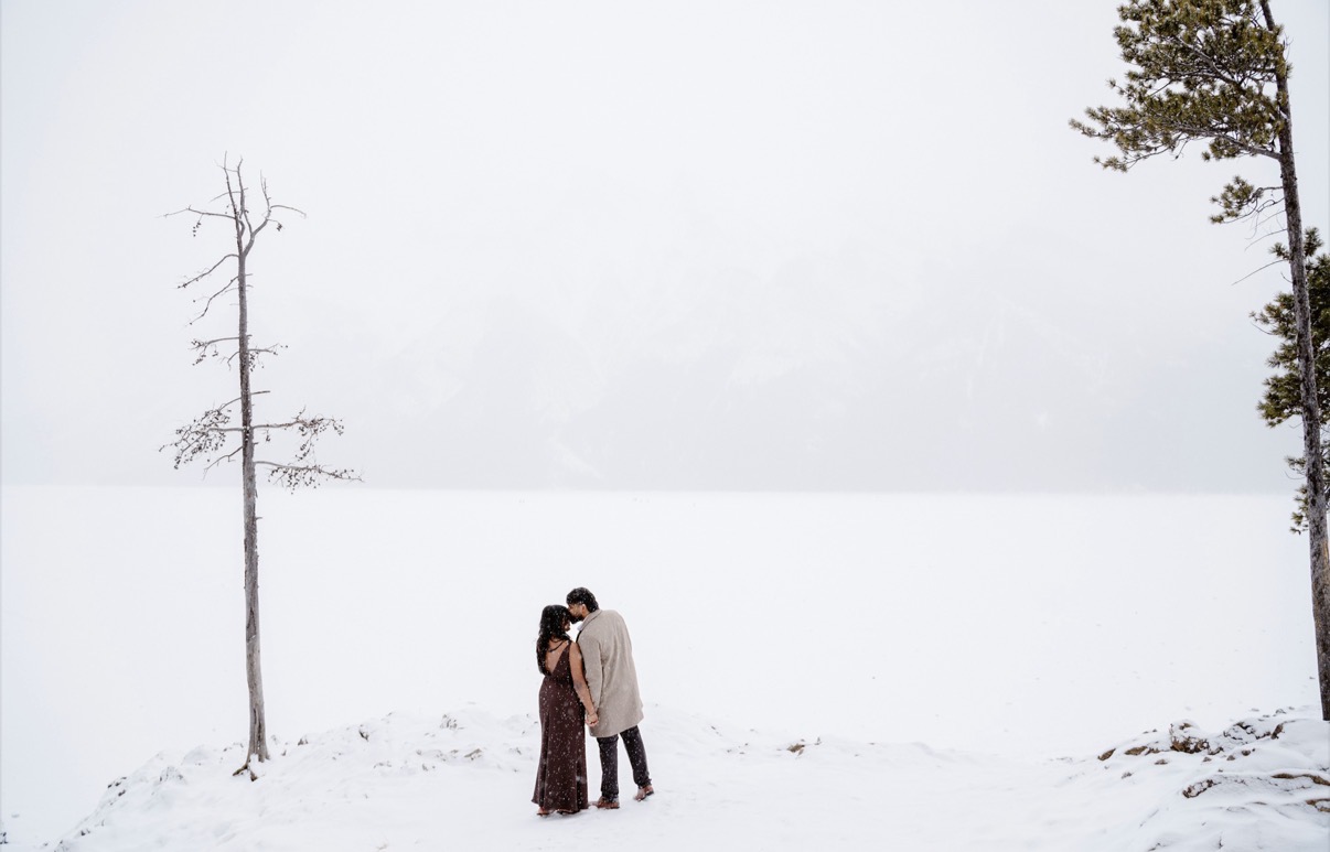 A quiet kiss on a frozen lake in the falling snow